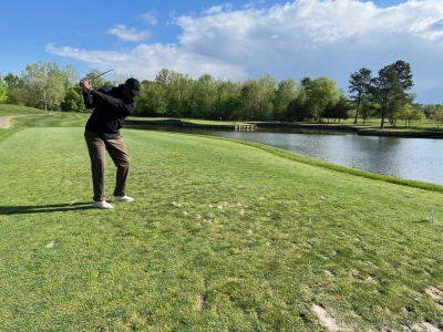 The Rev. Marion Easterling tees off at the island hole, a rendition of the famous 17 hole at TPC Sawgrass in Florida